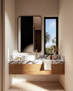 Baño con lavabo sobre encimera de mármol y mueble de madera